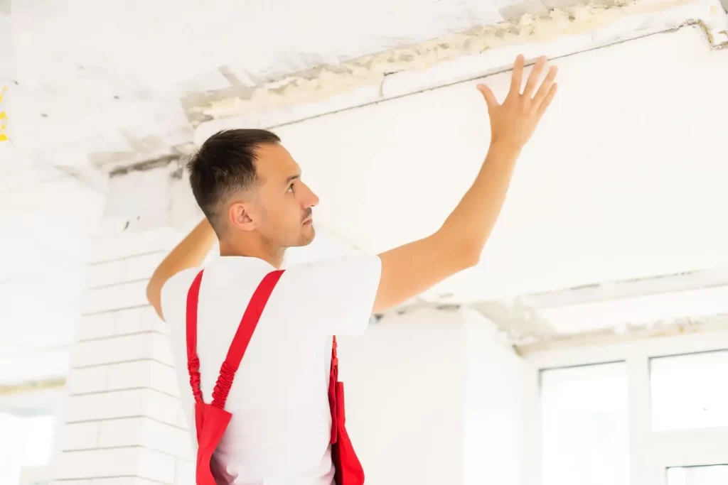 man replacing ceiling